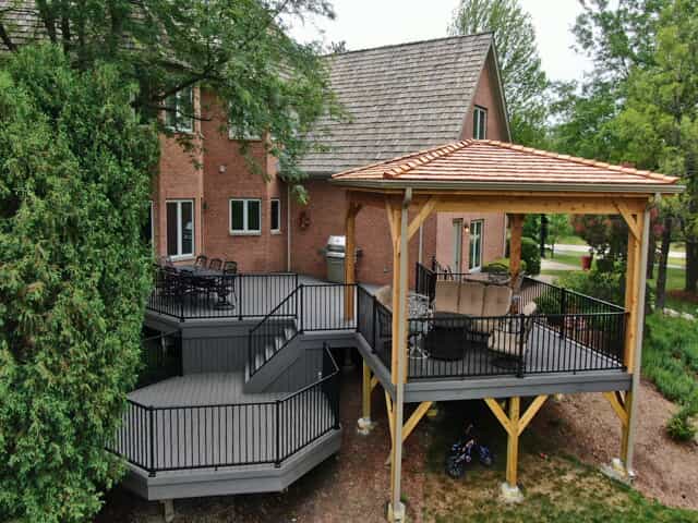 Multi-level TimberTech composite deck with an integrated open porch in Mundelein